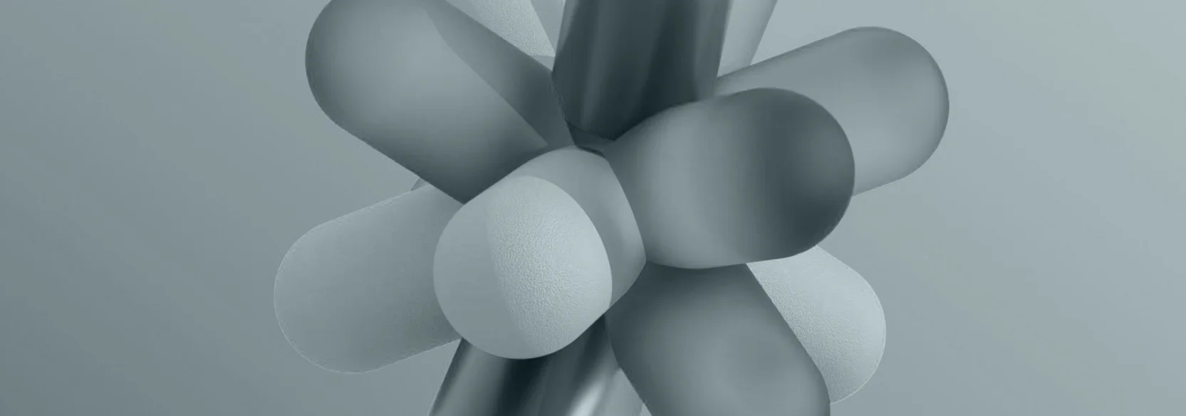Abstract composition of overlapping, rounded three-dimensional geometric shapes in soft grey and blue tones.